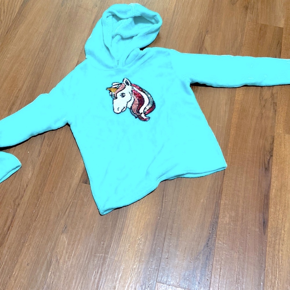 Baby blue sweater with sparkly unicorn in the center